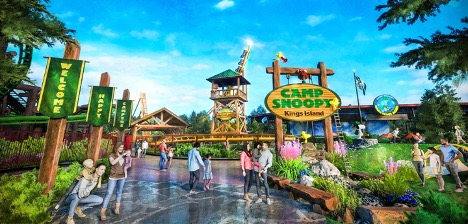 A park and a roller coaster behind a woodsy Camp Snoopy sign.